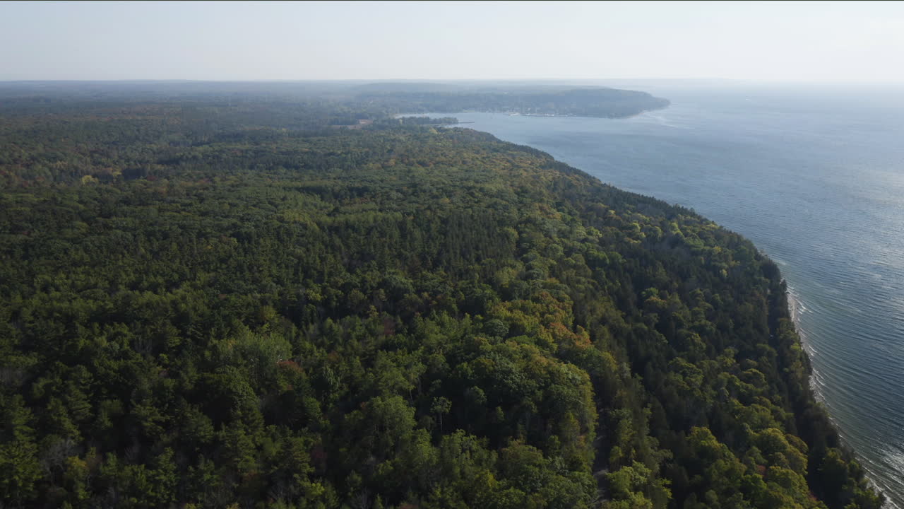 Vast stretches of green forest blanket the high bluffs of Door County as they meet the endless blue of Lake Michigan, forming a tranquil horizon where land and water merge in harmony