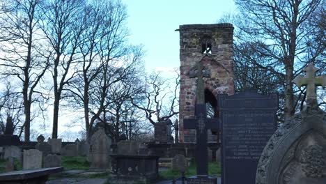 Windleshaw-Chantry-stonework-tower-and-graveyard-slow-motion-across-ruins-under-blue-sky