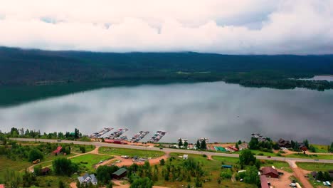 Beautiful-Clear-Mountain-Lake-with-Cars-Driving-on-Highway-Road-in-Grand-Lake-Colorado