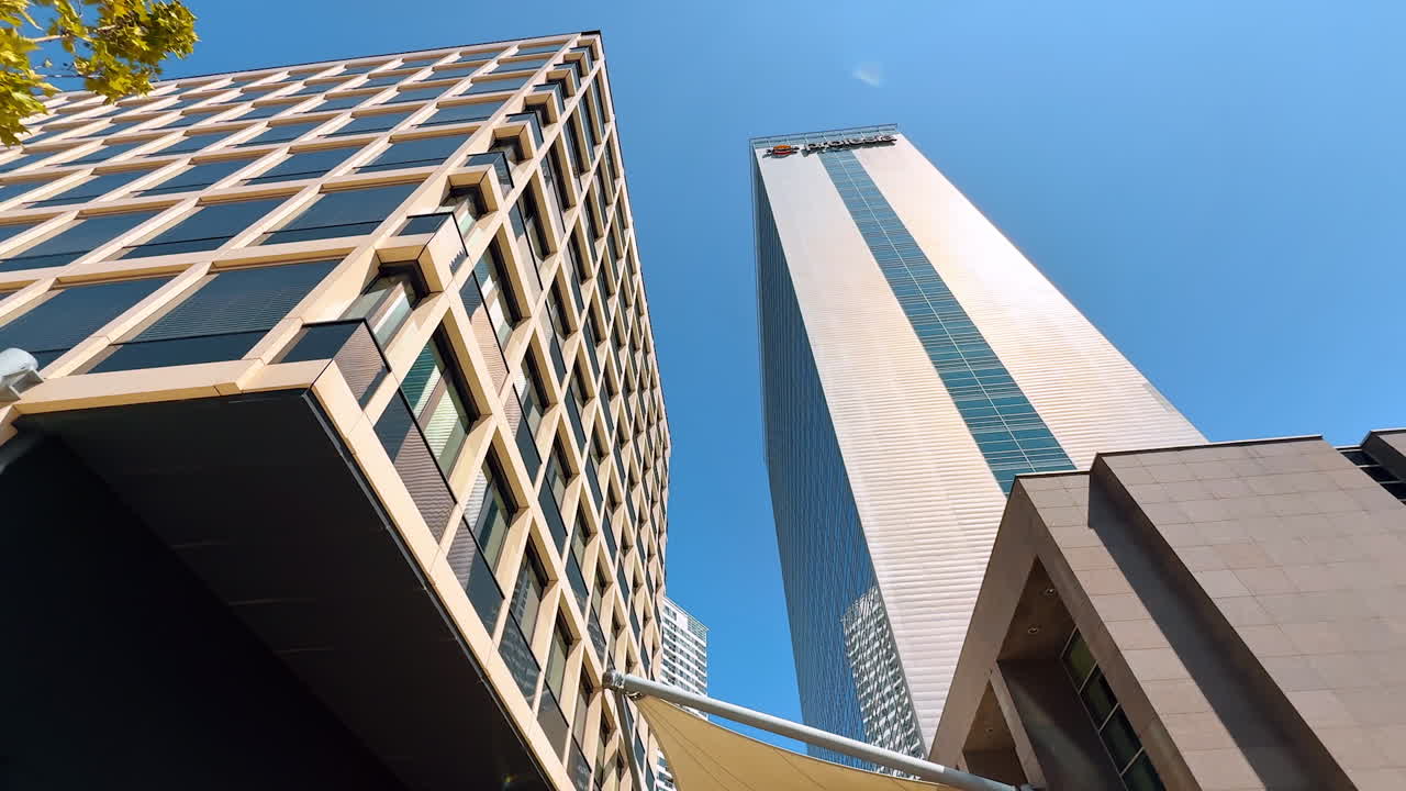 Modern architecture in skyline. Tall buildings under a bright blue sky showcase contemporary design in a bustling city environment