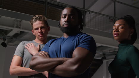 Group-Portrait-Of-Male-And-Female-Athletes-In-Fitness-Clothing-Training-In-Gym-Warming-Up-And-Preparing-Psychologically-For-Sports-Event-7