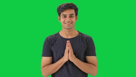 cute indian boy doing namaste green screen