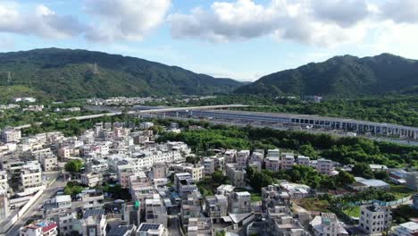 Hong-Kong-Pat-Heung-village-houses-with-MTR-maintenance-centre,-Aerial-view