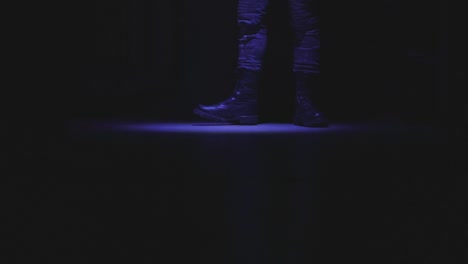 a man stepping randomly in entrance hall with low light environment