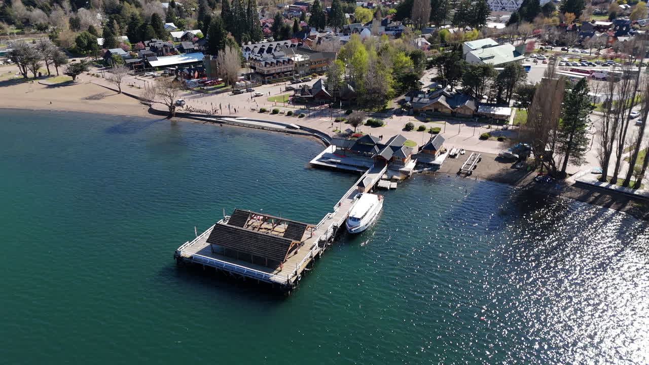 Aerial view of picturesque wooden pier with boat on Lácar lake in San Martín de Los Andes, Neuquén, Patagonia Argentina