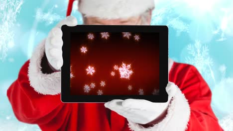 santa usando una tableta con copos de nieve