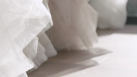 a close-up of the bottom of a wedding dress in a wedding salon