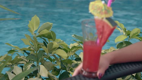 branches with green leaves shake slowly near girl with drink