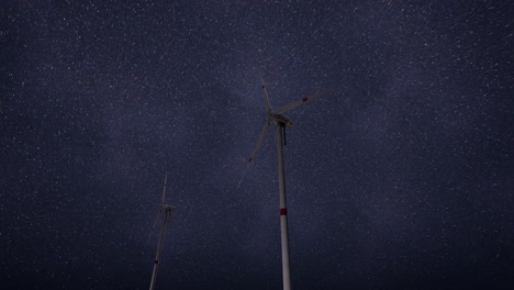 wind turbines under a starry night sky