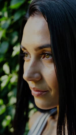 close-up portrait of a serene woman in nature