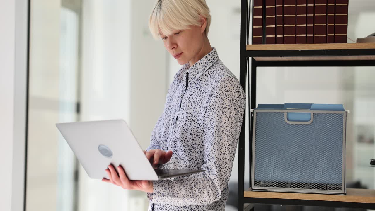 Woman working on laptop in an office setting