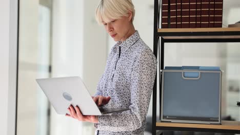 woman working on laptop in an office setting