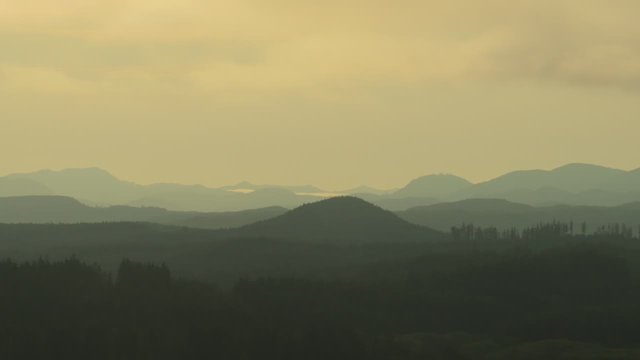 Sunset Sky Over The Mountains With Misty Forest In Vancouver Island - Drone Shot