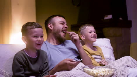 father and sons watching funny movie