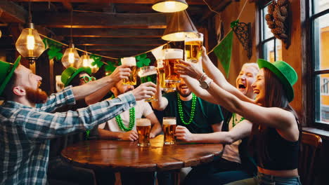 friends celebrating st. patrick's day with beers at a pub