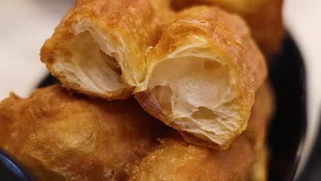 detailed view of golden, crispy dough sticks highlighting their texture and color.