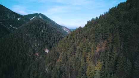 drone shot of hills and mountains landscape with forests and some snow, in slovakia, on a sunny day