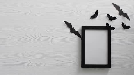 Video-of-black-frame-and-bats-with-copy-space-on-white-background