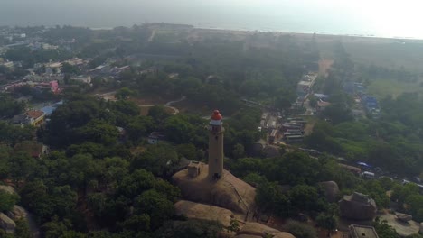 Light-house-of-mamallapuram-situated-among-famous-Rock-cut-Pallava-era-temples,-aerial-view-shot-on-Phantom-4-pro-4K-drone