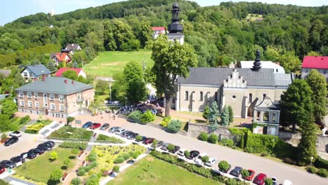 Aerial-footage-of-the-Roman-Catholic-Parish-Church-of-All-Saints-and-its-scenic-surroundings-in-Babice,-Poland