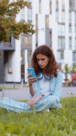 surprised preteen child kid use smartphone loses bad news fortune loss fail outdoors in city park