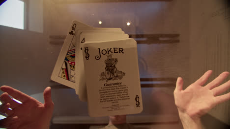 magic trick with floating joker playing cards