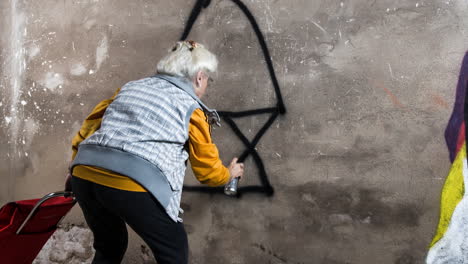 rebel grandma graffiti artist against an urban wall