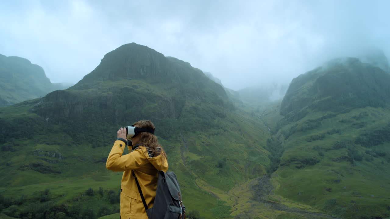 mujer con auriculares vr disfrutando de una vista del paisaje montañoso