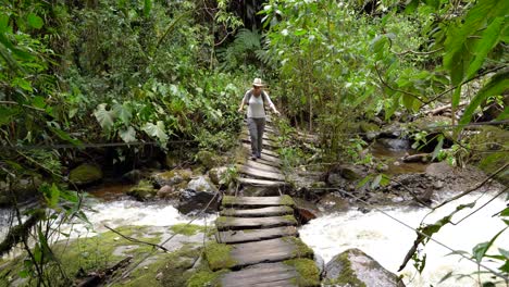 Woman-traveler-walking-on-footpath-above-river