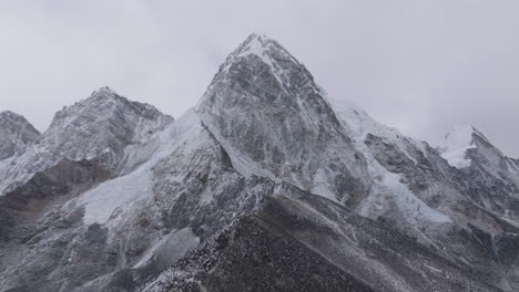 drone view of mount pumori and kalapatthar view point on the everest base camp trek in nepal, less snowfall, gloomy skies, changing weather patterns, climate crisis, and adventurous himalayan trails