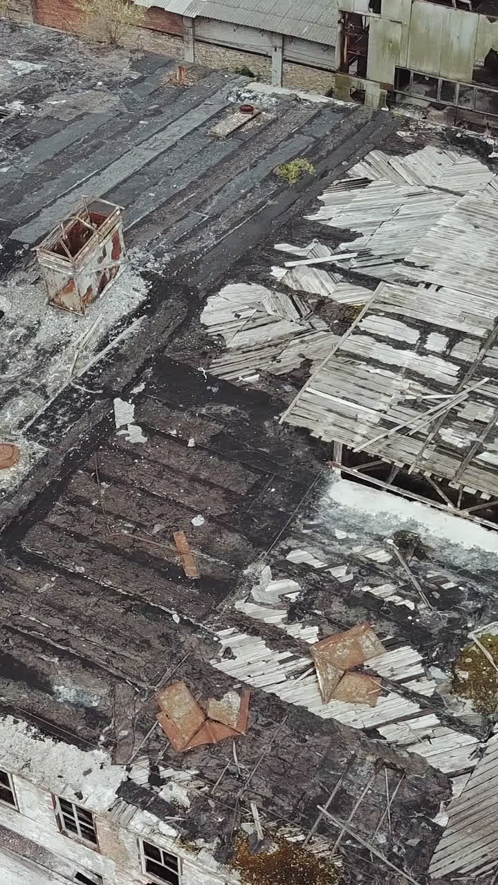 Ruins of a very heavily polluted industrial factory. Old industrial building for demolition. Aerial view. Vertical video