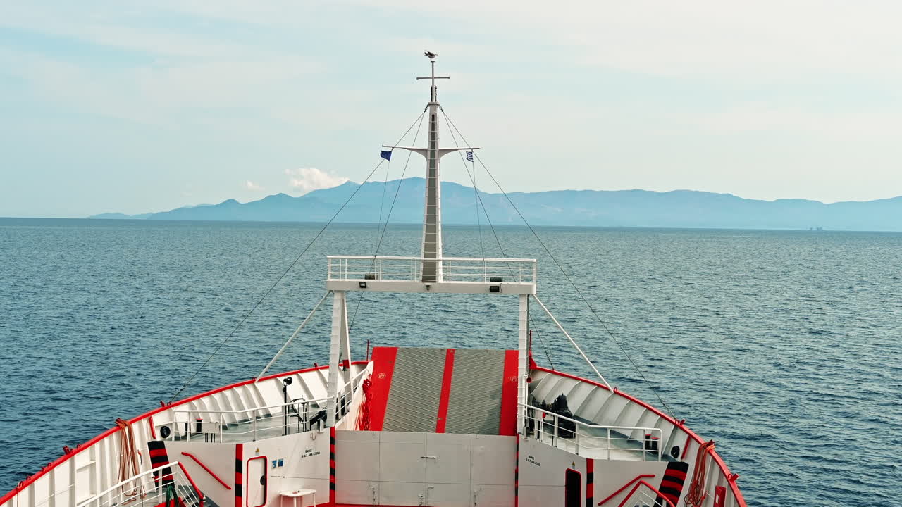View of the Aegean sea from a ferryboat with visible prow of the ship, Thassos island in the distance, Greece