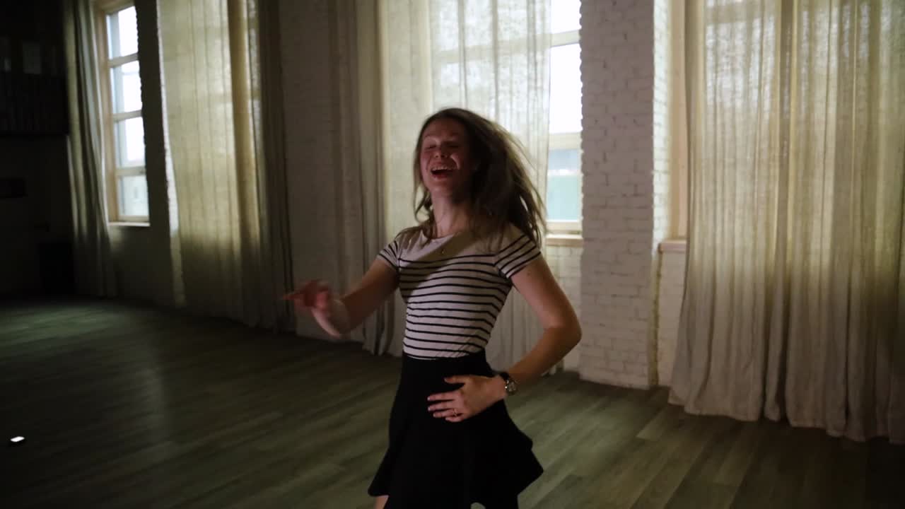 Short clip of teenage girl dancing in the studio slow motion