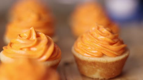 close up of little cupcake placed on a wooden surface