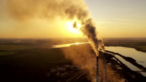 smoking factory chimney. plant emits smoke and smog from the pipes at sunset, pollutants enter the atmosphere