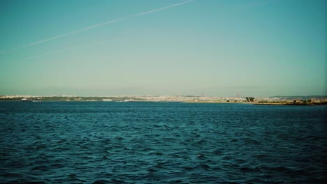 Nature-Shore-Lake-Waves-Wind-Sunny-Daylight-Ferry-Boat-Boat-Ship-Passing-Steady-Shot-4K