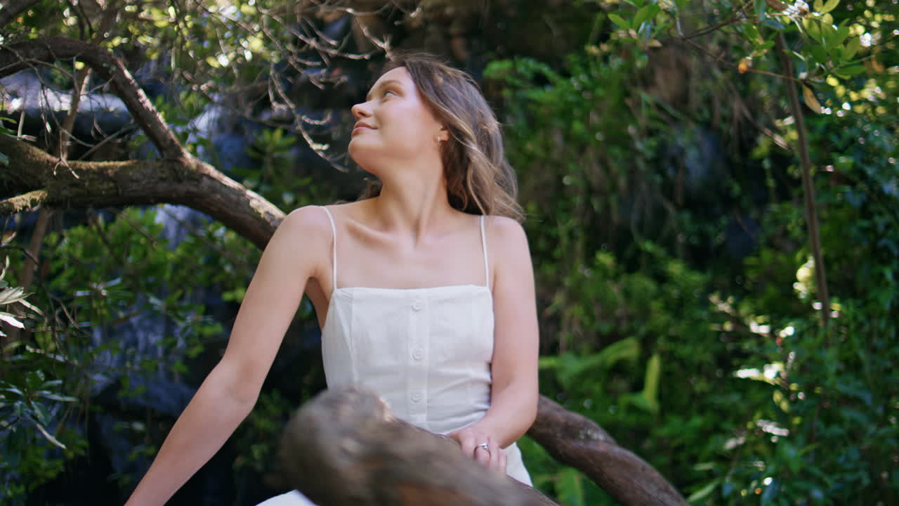 Portrait woman posing nature resting on greenery tree. Lady enjoying waterfall