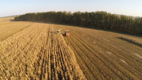 aerial view of agricultural vehicles gathering crops