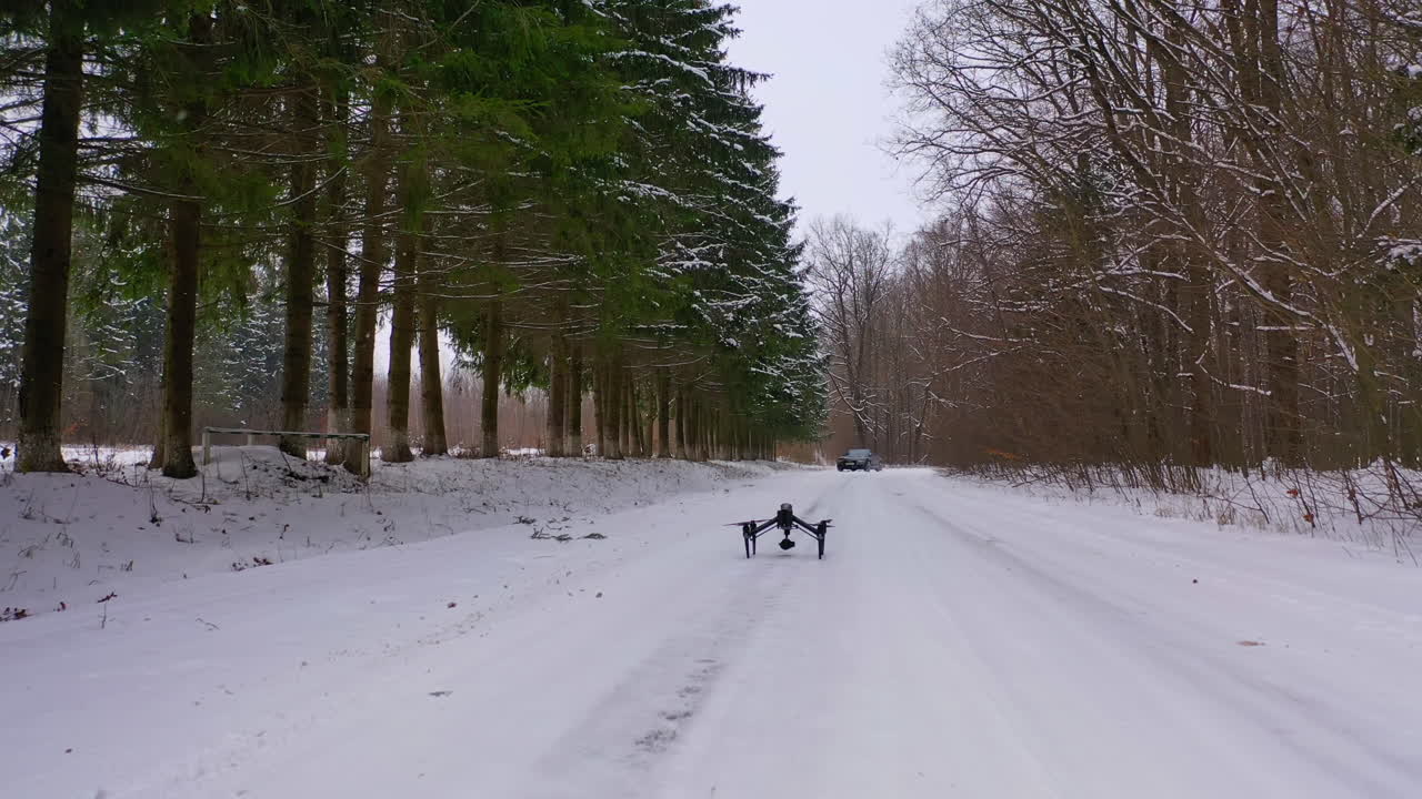 Drone stands on road. View of drone with camera standing on road