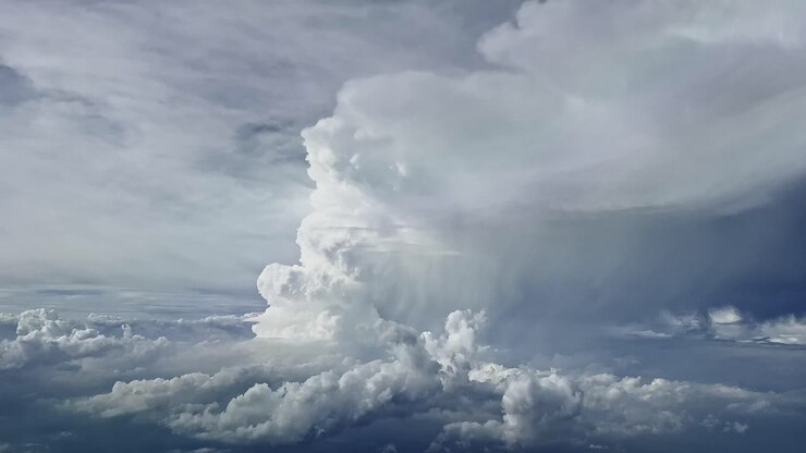 Dramatic aerial view recorded from a jet cockpit of a huge and very actice cumulonimbus impossible to overfly