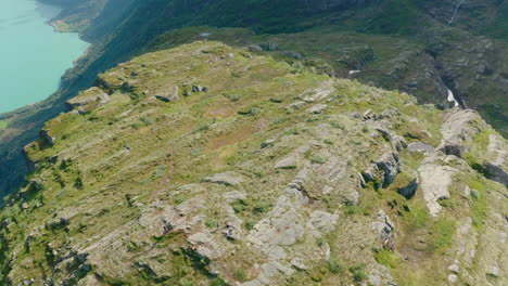 Top-View-Of-The-Rugged-Landscape-Of-Klovane-Peak-And-Turquoise-Water-Of-Oldevatnet-Lake-In-Olden,-Norway