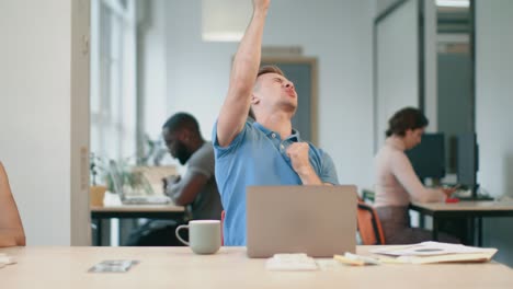 happy business man enjoy good news at office. freelance man jumping at coworking