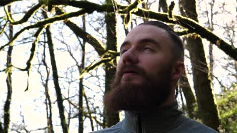 headshot of young bearded man amidst beautiful nature