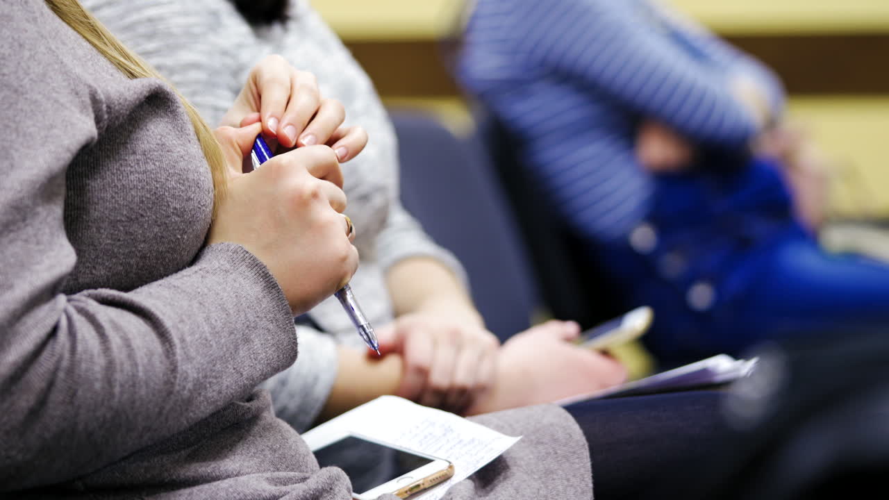 Close-up of business human hands writing in paper. Business seminar.