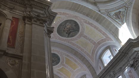 frescoes on the vaulted ceiling and detailed columns inside bom jesus do monte church, braga, portugal