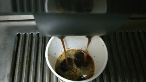 pouring coffee from the coffee vending machine