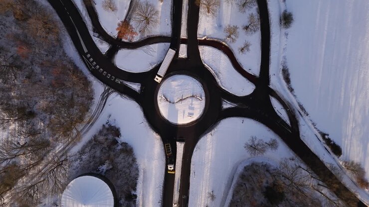 Aerial view of a roundabout in winter with snow covering the ground