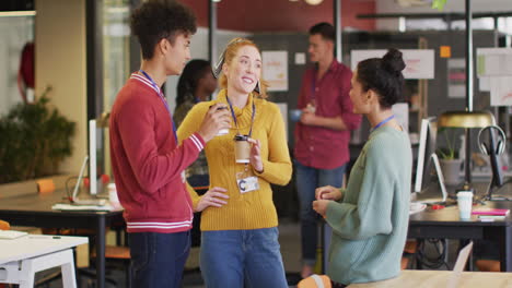 Happy-diverse-business-people-discussing-work-during-meeting-at-office