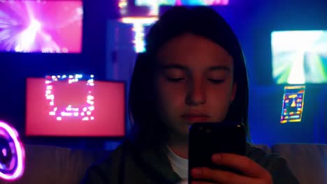 teenage girl using smartphone in a room with glowing screens