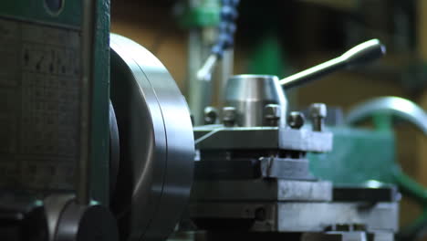 professional engineer metalworker industrial experienced operator technician worker skilled machinist working intently on a large industry in metal factory workshop with large machines